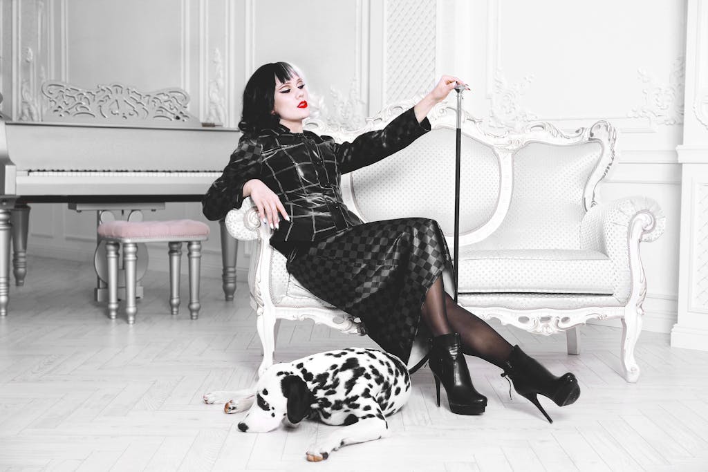 Chic woman in fashion attire with Dalmatian dog in vintage interior setting, exuding elegance.